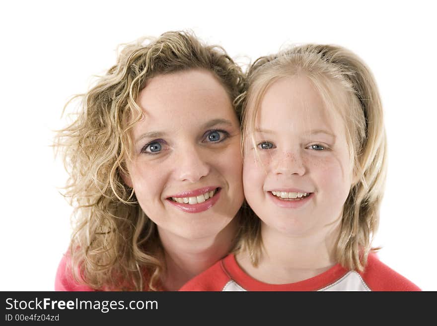 Mother and daughter happily posing in front of the camera, isolated on white