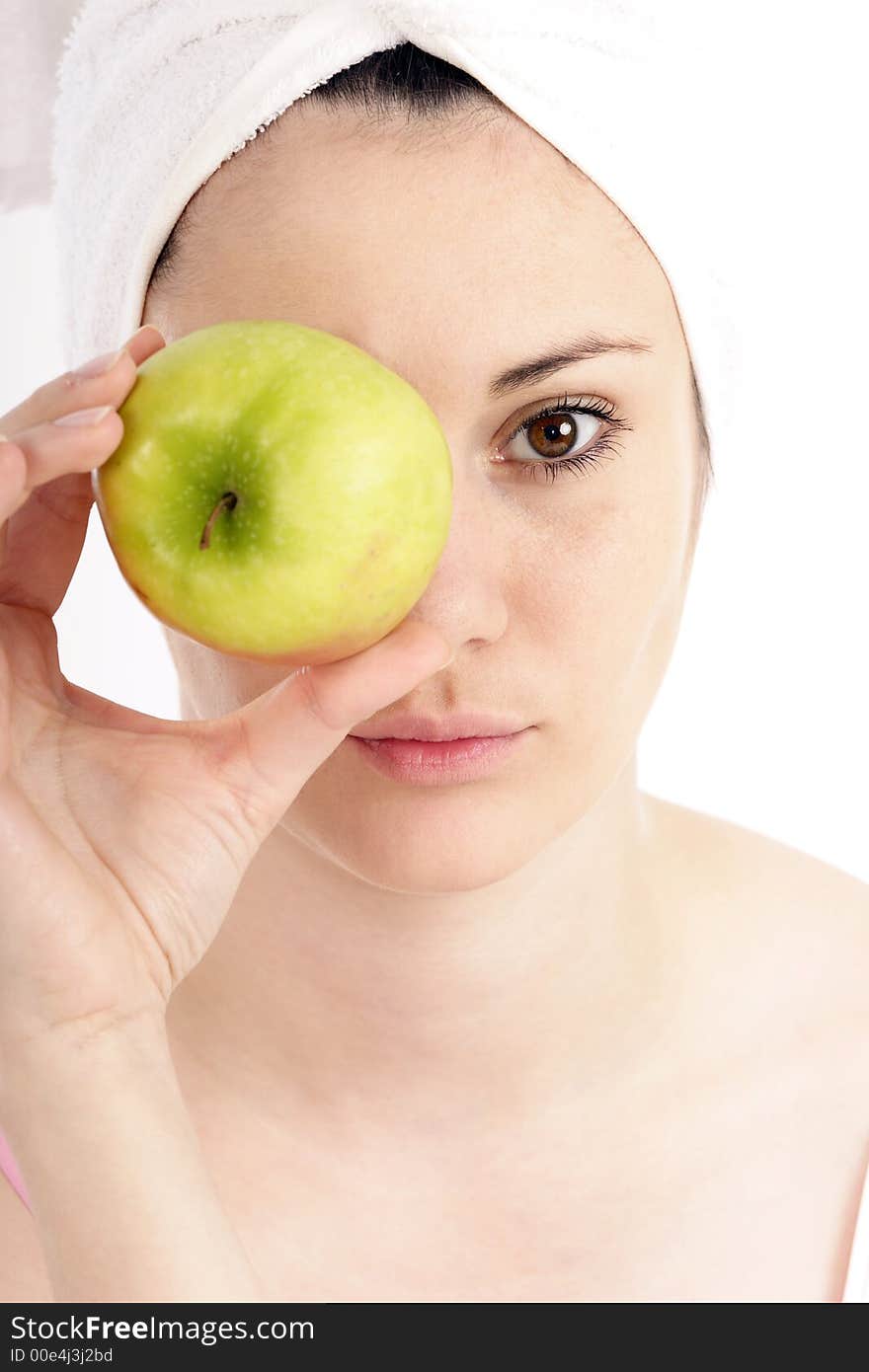 Stock photo of a young woman with green apple