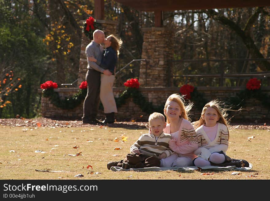 Family posing in on grass for a family portrait