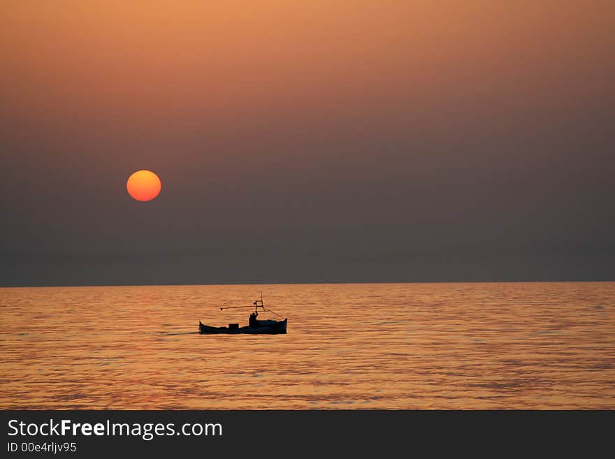 Small ship in the first sun rays