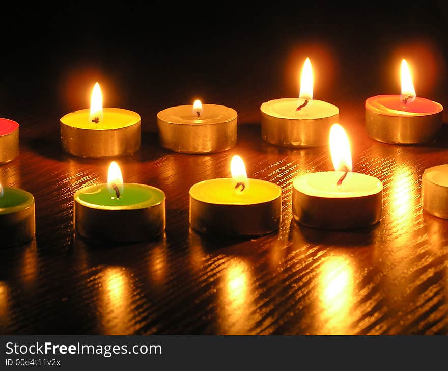 On a photo of a candle as different figures. A photo on a dark background. The photo is made in Ukraine. On a photo of a candle as different figures. A photo on a dark background. The photo is made in Ukraine.