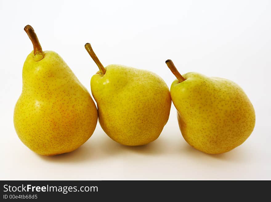 Three yellow pears on white background