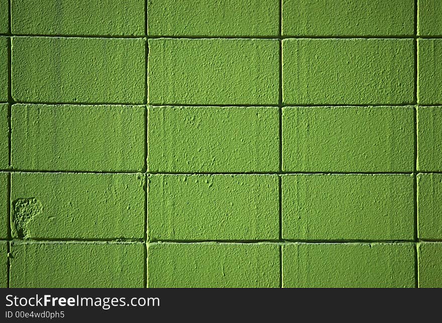 A brick wall with green paint. A brick wall with green paint