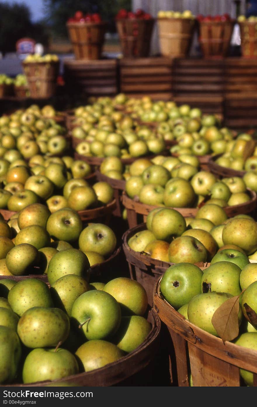 Bushel baskets of harvested green apples at outdoor market. Bushel baskets of harvested green apples at outdoor market