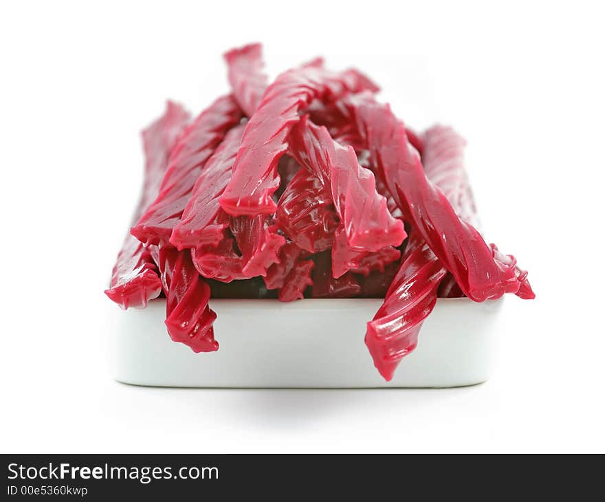 Red licorice candy over the white background