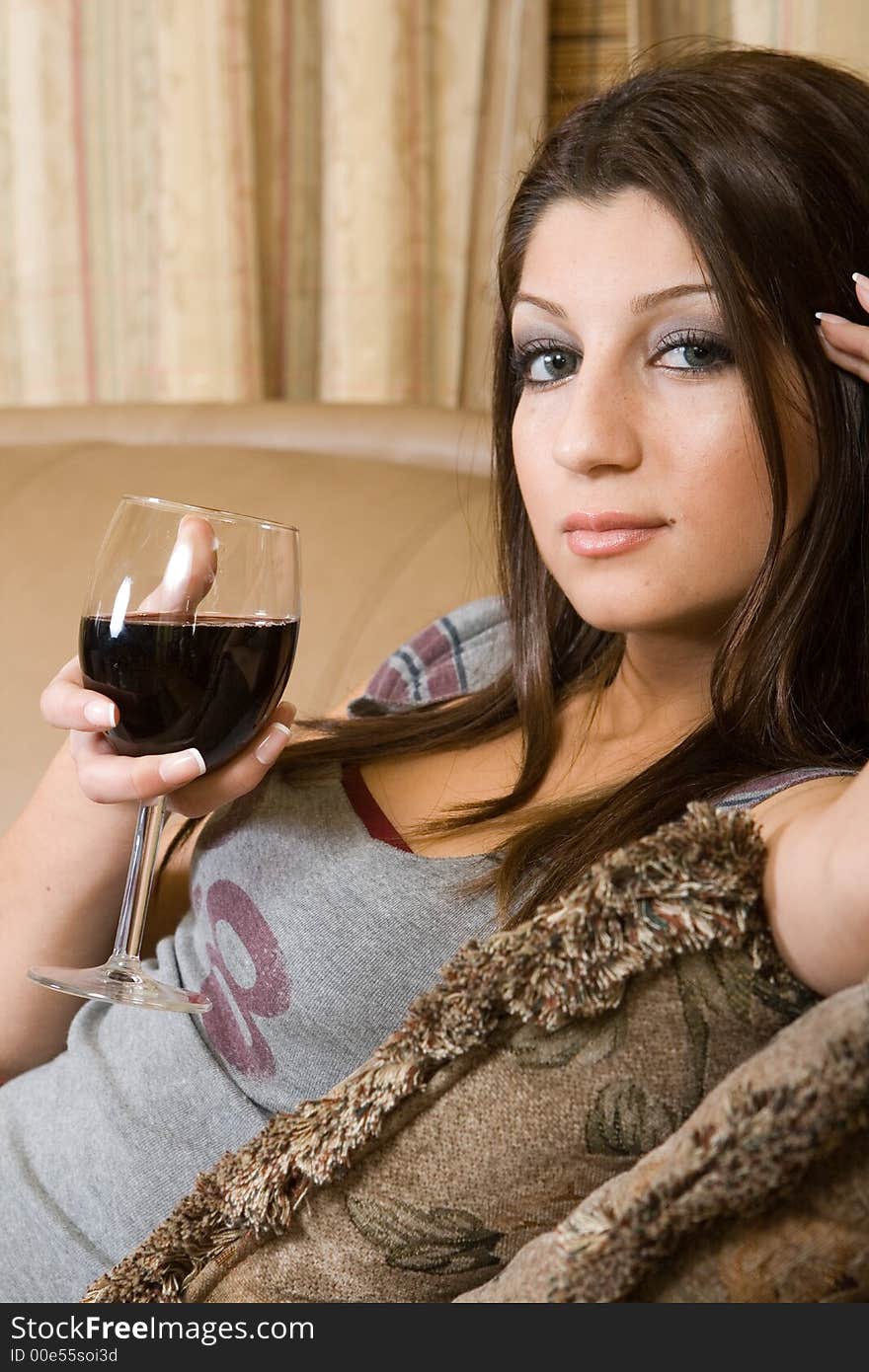 Women drinkin a glass of red wine. Women drinkin a glass of red wine.