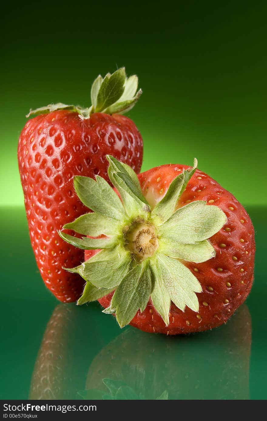 Fresh red strawberries on green background