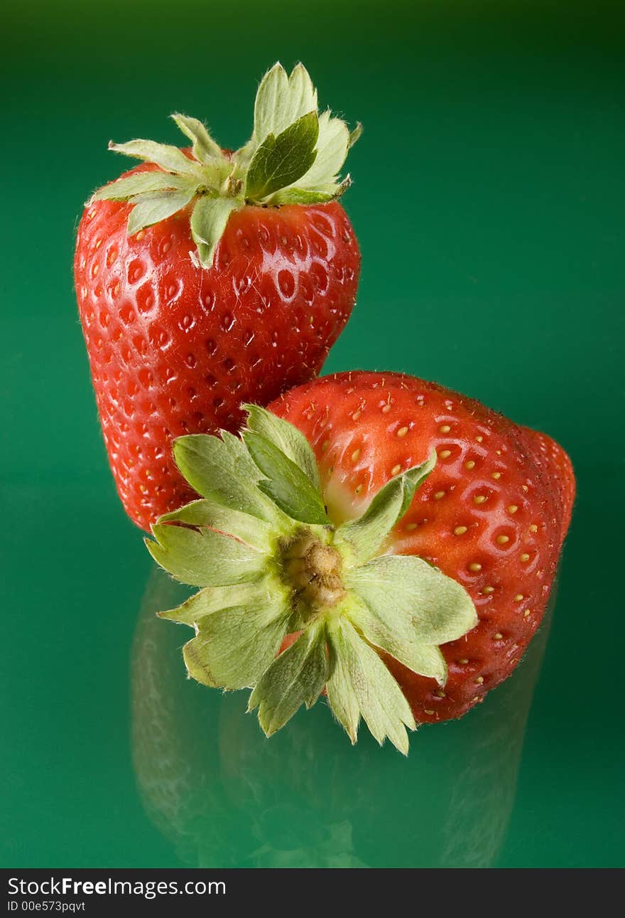 Fresh red strawberries on green background