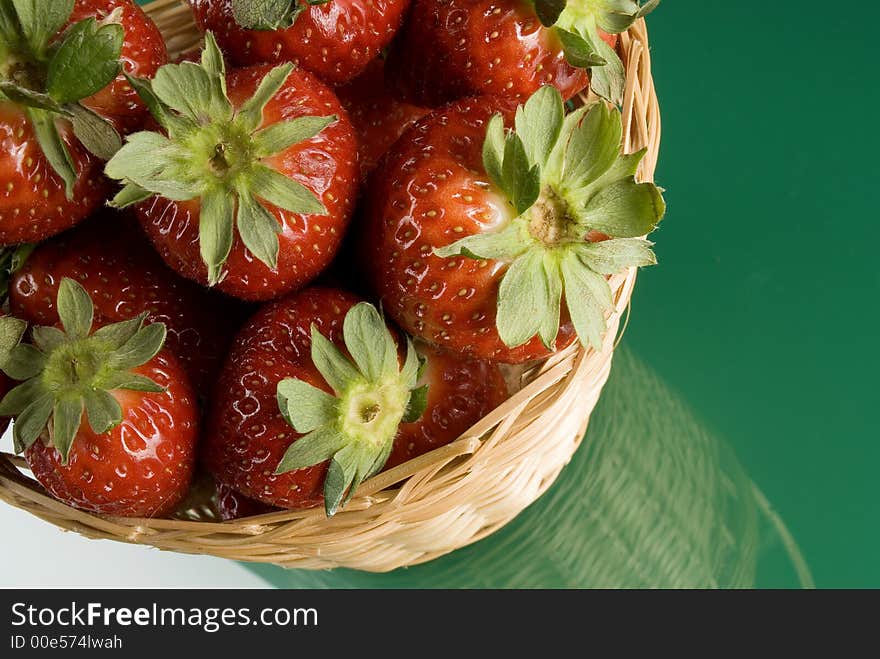 Fresh red strawberries on green background