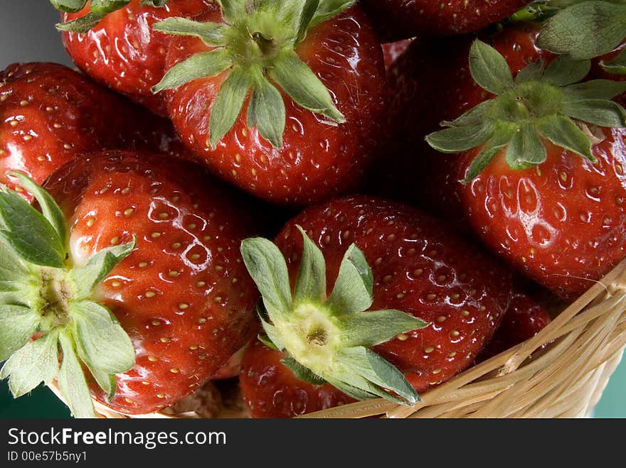 Fresh red strawberries on green background