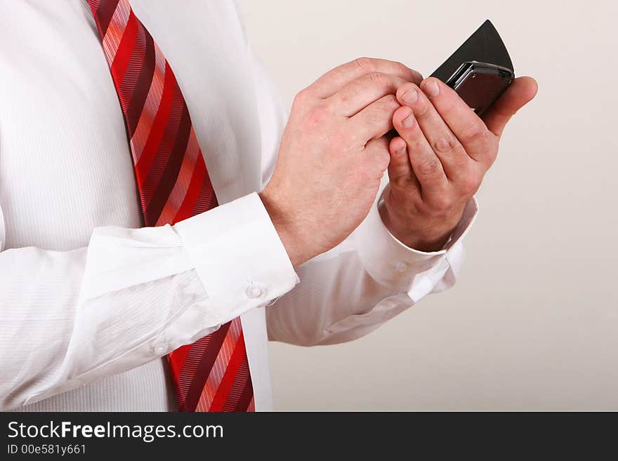 A man in shirt and tie writing on a pda. A man in shirt and tie writing on a pda