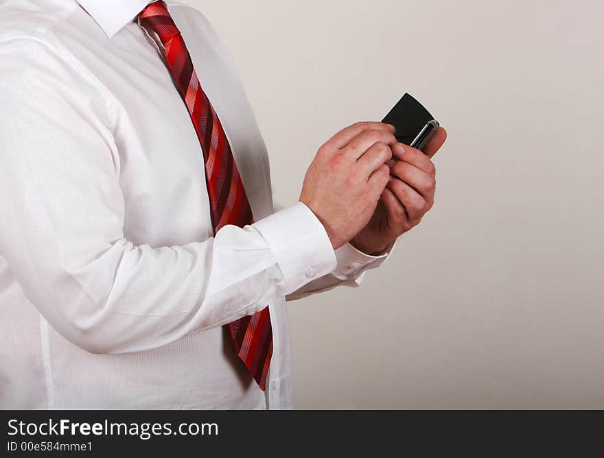 A man in shirt and tie writing on a pda. A man in shirt and tie writing on a pda