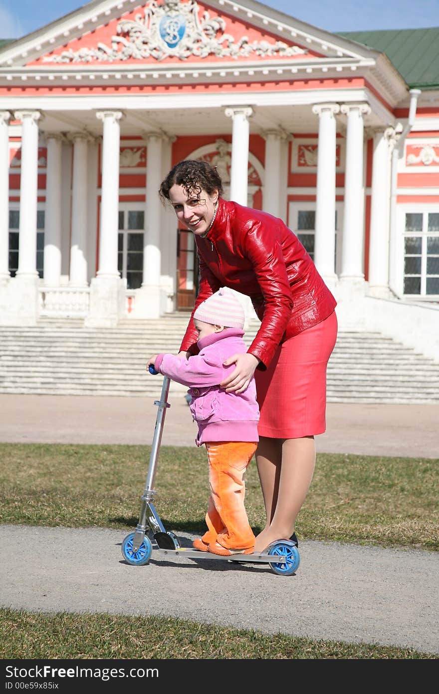 Mother with baby on scooter