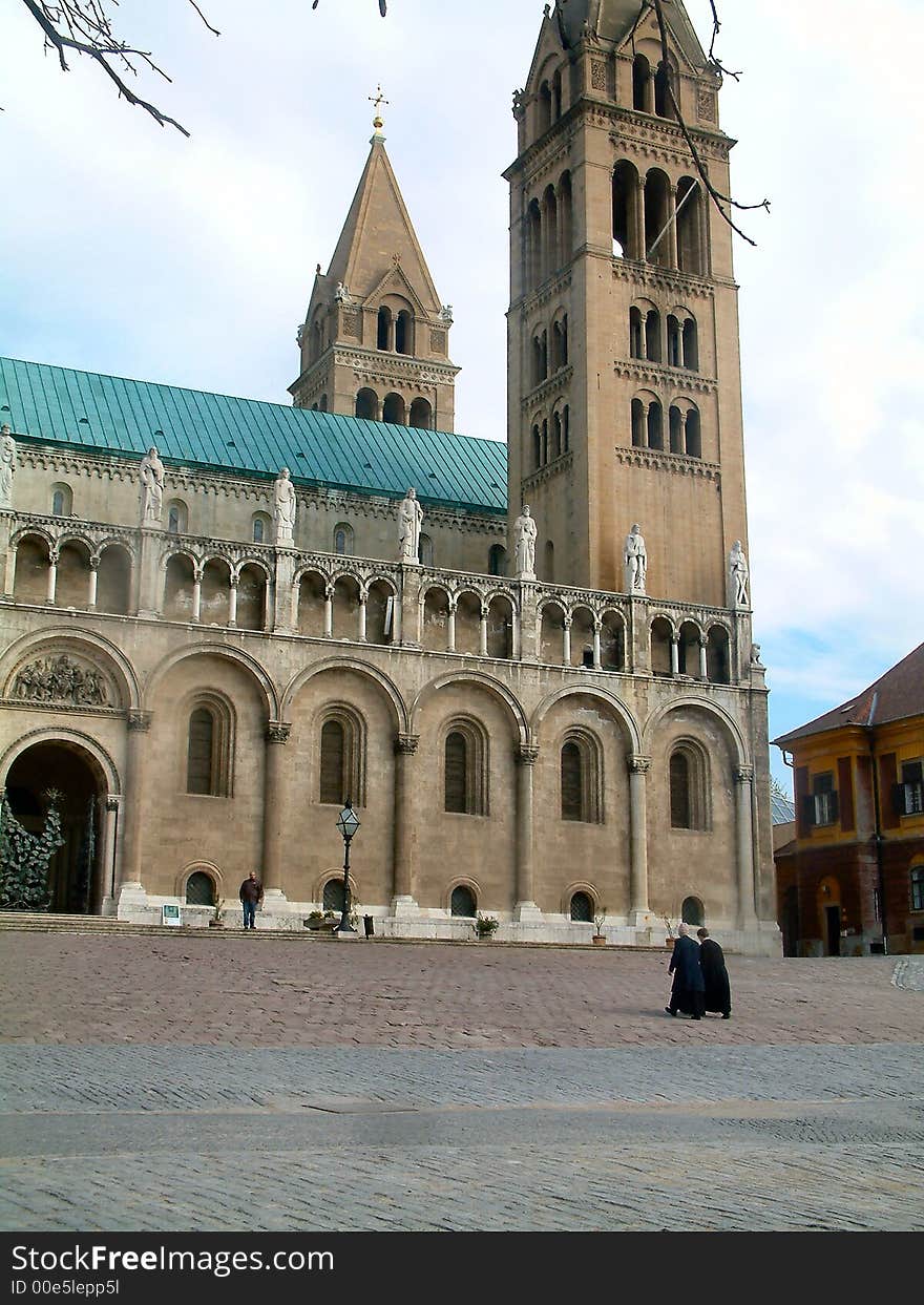 Two priests are walking back to the cathedral.