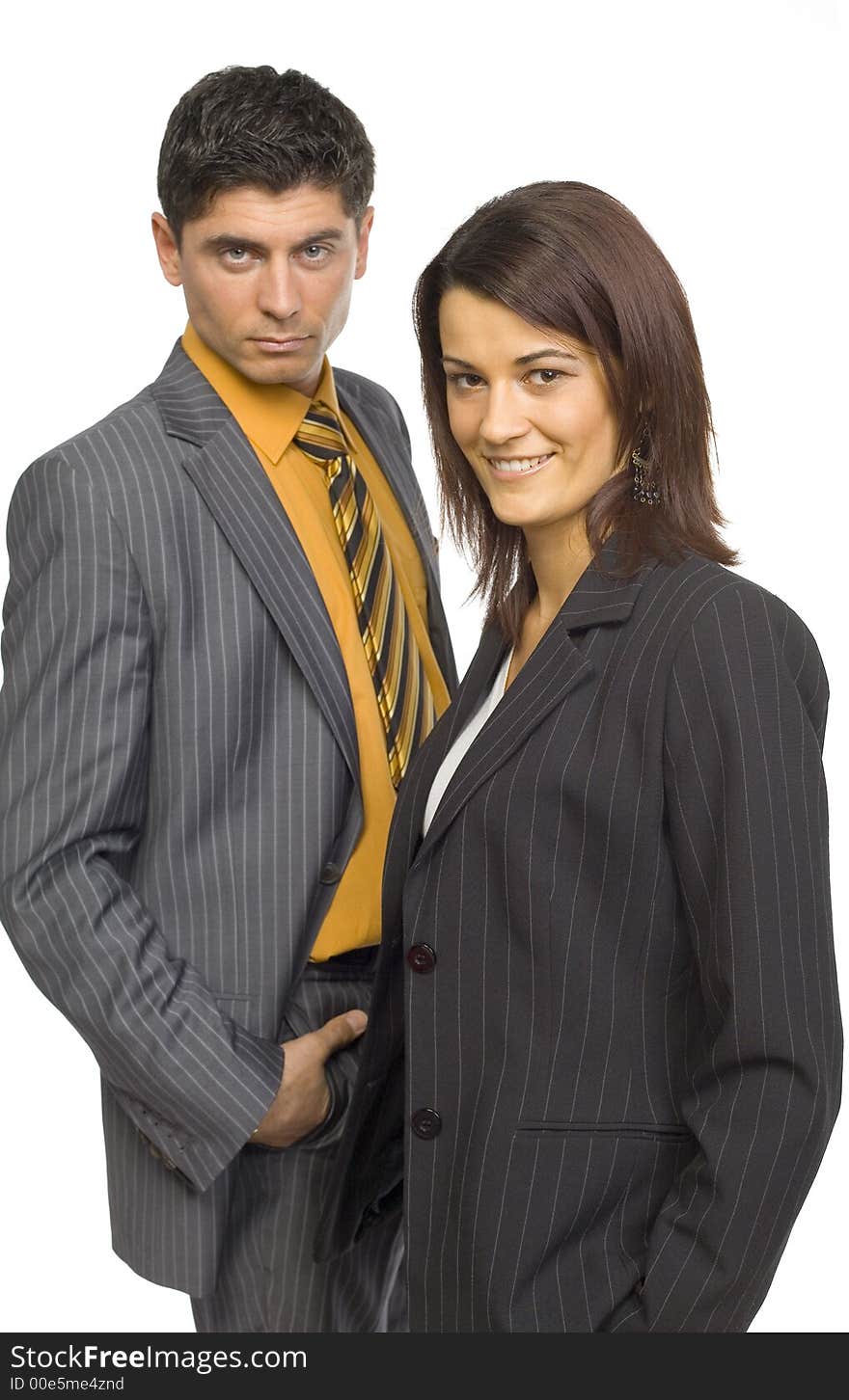 Formalwear man and woman are standing and looking at camera. Woman on the front. Focus on her face. Isolated on white in studio. Formalwear man and woman are standing and looking at camera. Woman on the front. Focus on her face. Isolated on white in studio.