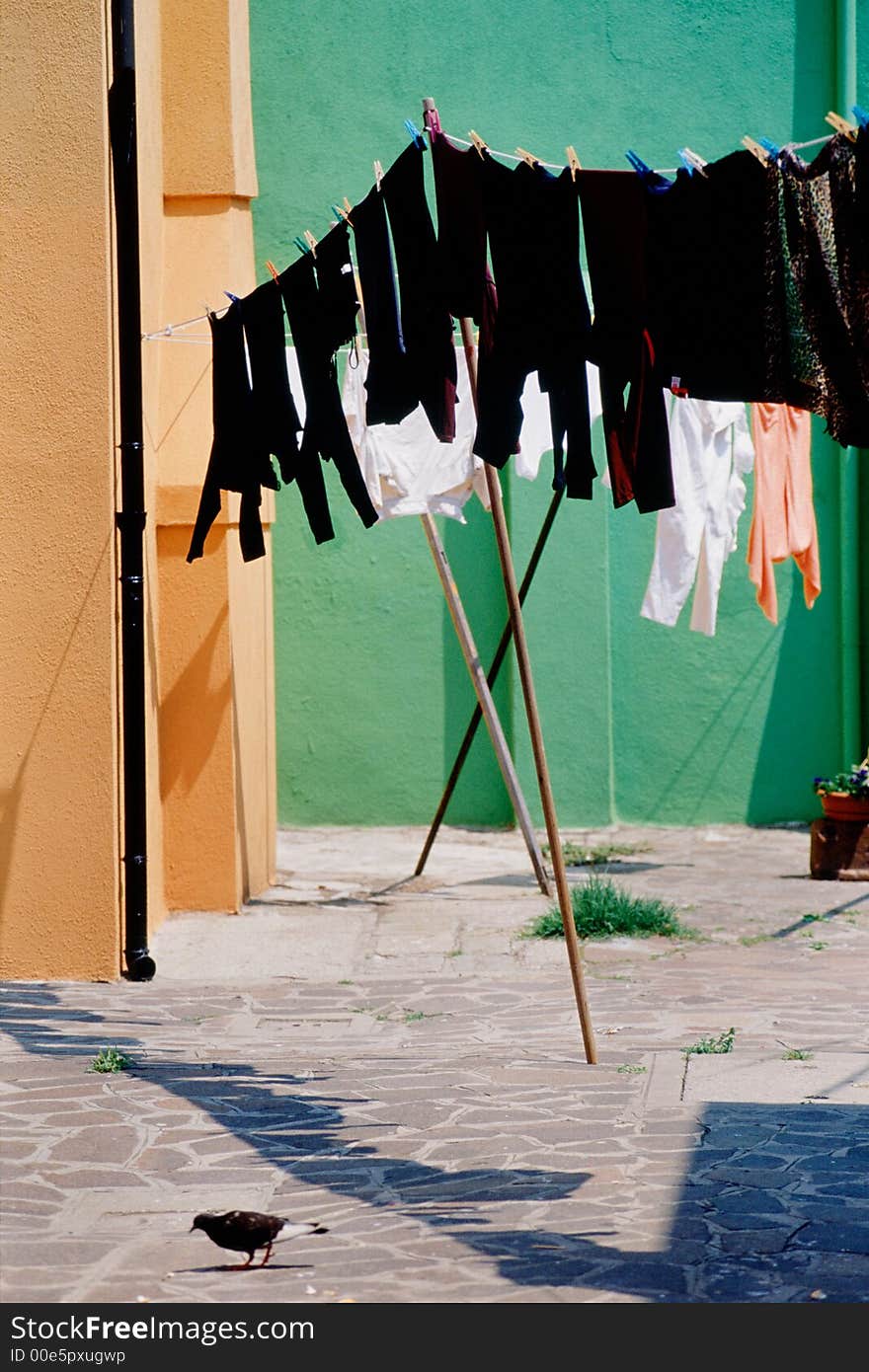 Laundry hanging outdoors on clothesline in Burano, Italy. Laundry hanging outdoors on clothesline in Burano, Italy