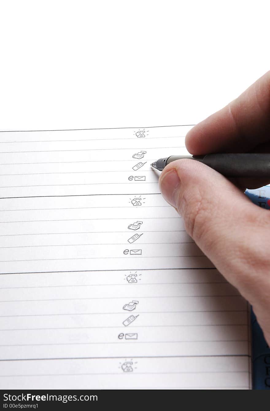 Male hand writing on white sheet of paper.