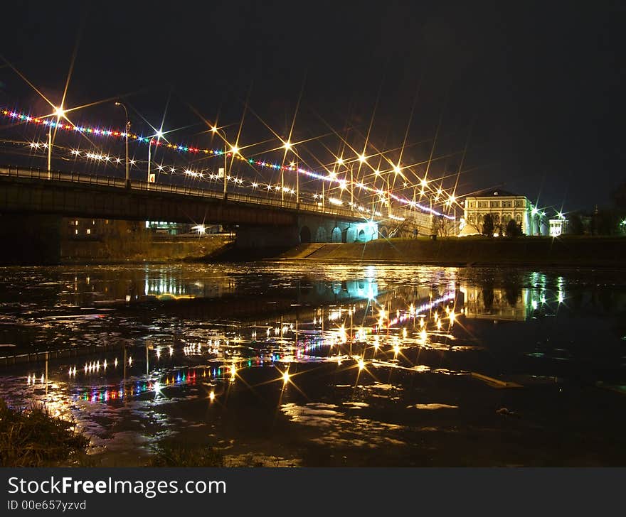 Bridge in the late evening, decorated by celebratory garlands. Bridge in the late evening, decorated by celebratory garlands