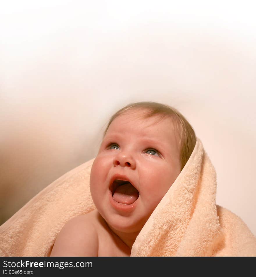 Porttrait smiling baby in bath towel