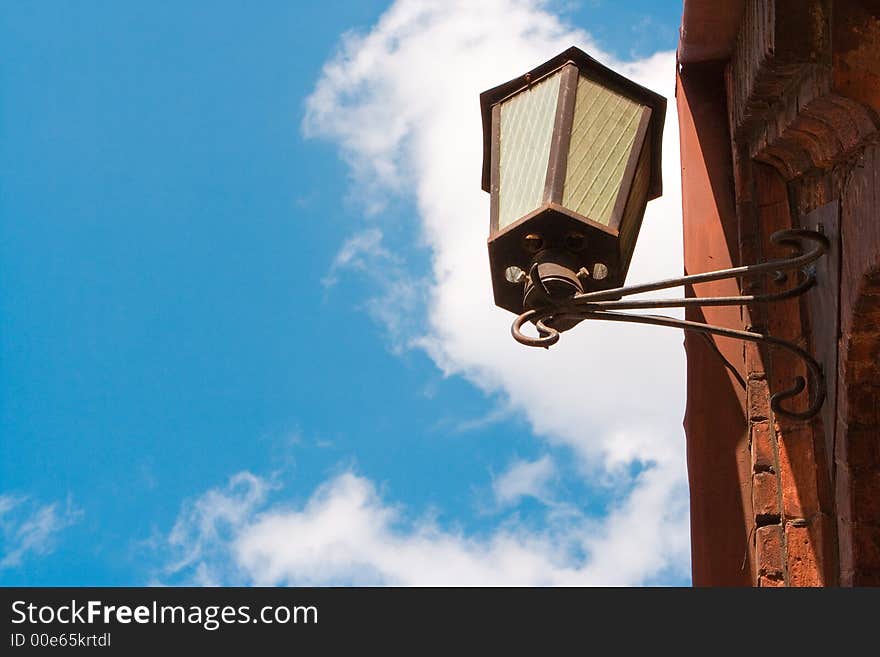 Old street lantern on a background of  blue sky