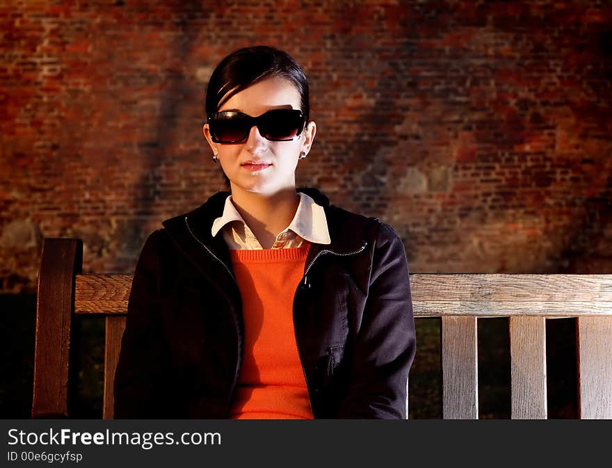 Photo of pretty female on a bench. Photo of pretty female on a bench.