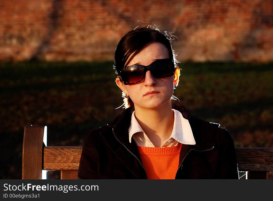 Photo of pretty female in sunshine light with cell phone. Photo of pretty female in sunshine light with cell phone.