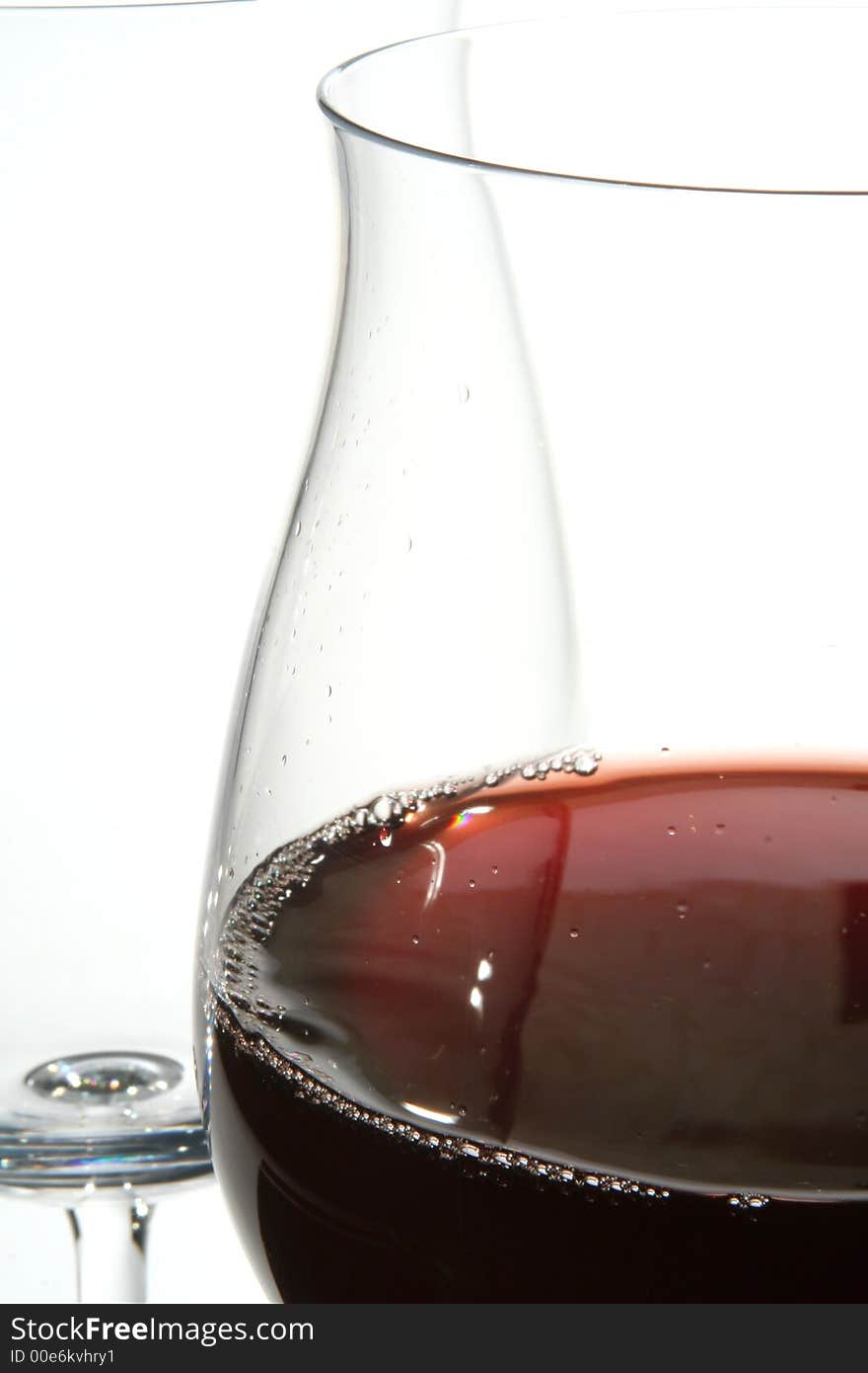 Two wine glasses with red wine close up on grey background