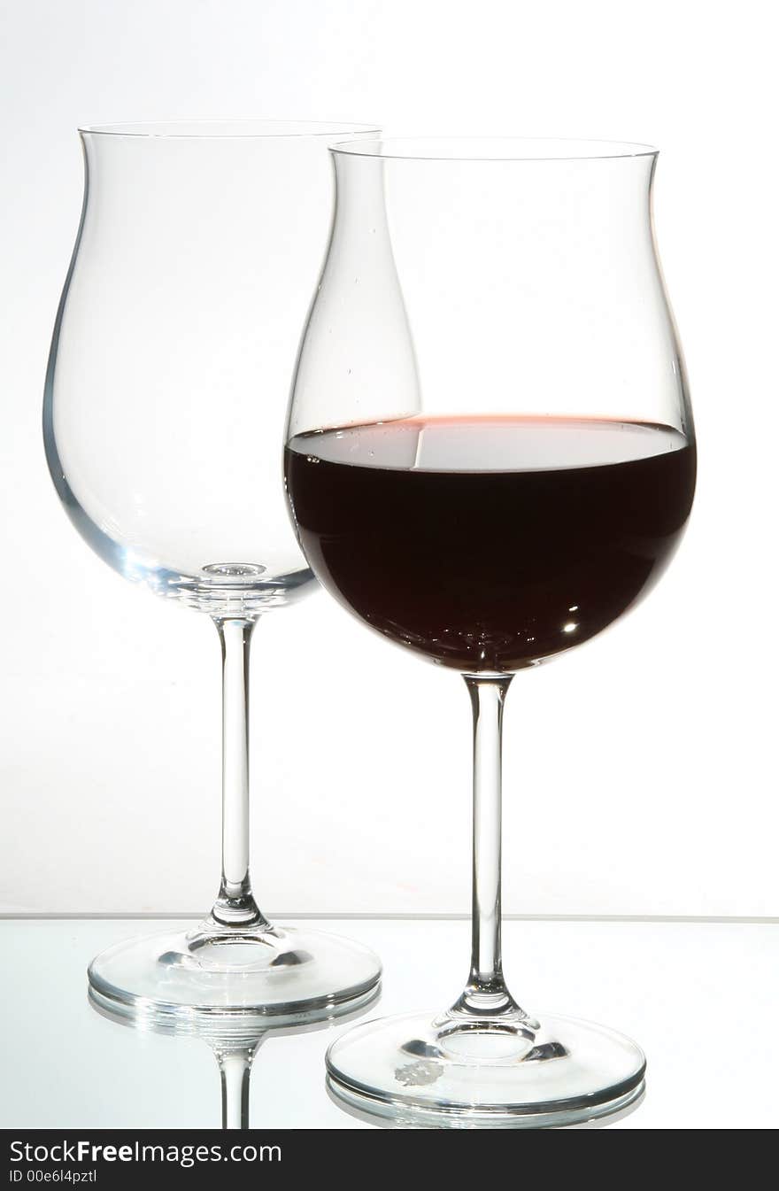 Two wine glasses with red wine close up on grey background