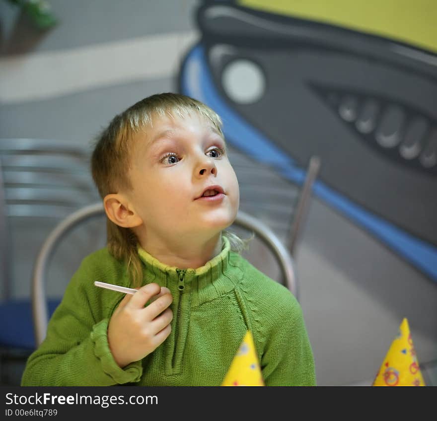 The little boy behind a table at restaurant. The little boy behind a table at restaurant