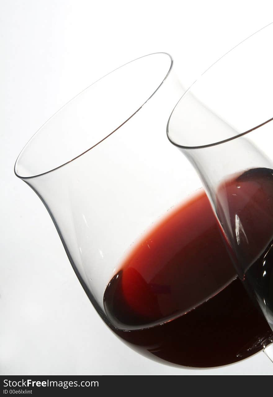 Two wine glasses with red wine close up on grey background