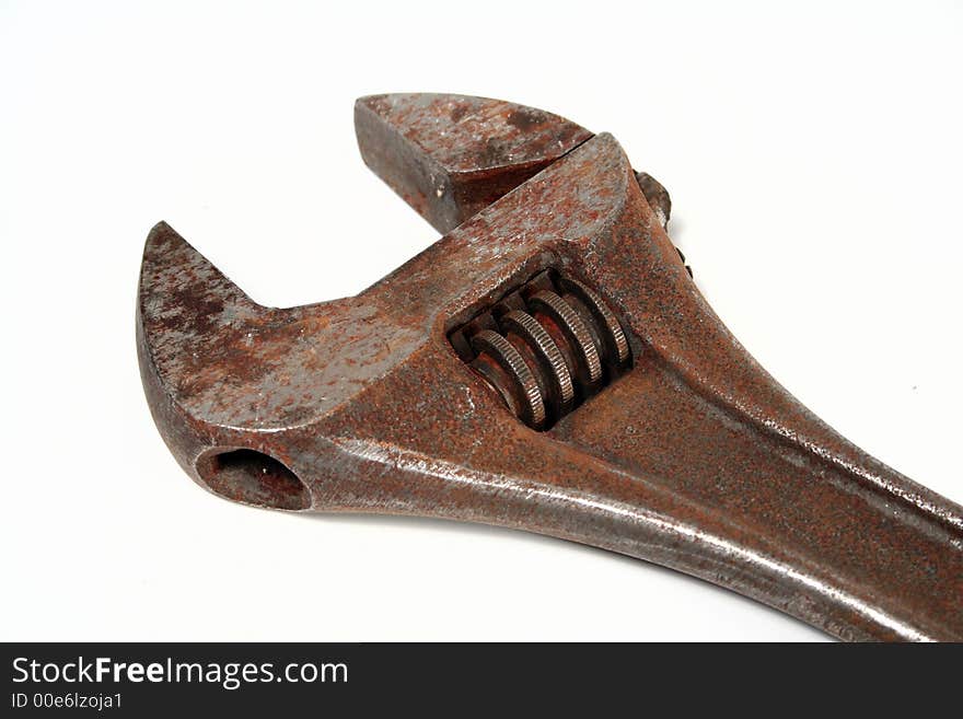 A rusty old monkey wrench isolated on white background. A rusty old monkey wrench isolated on white background.