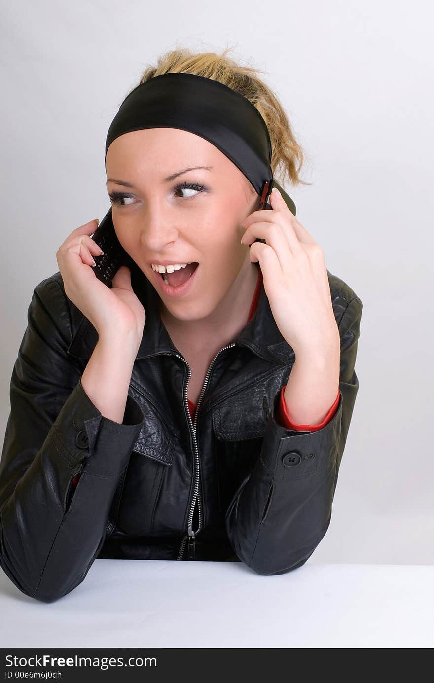 Young girl talking on the two mobiles. Young girl talking on the two mobiles