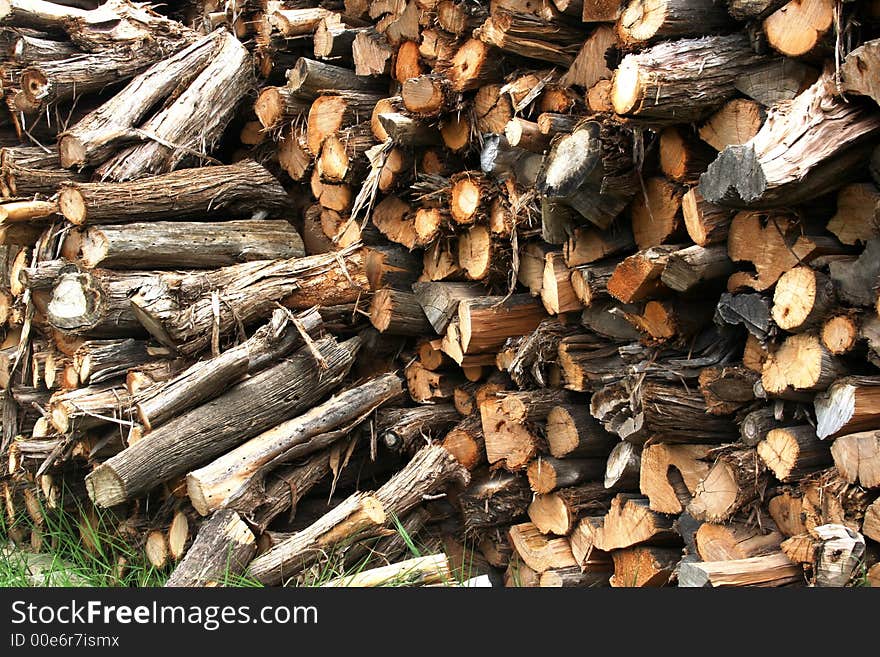 Several cords of wood ready to be used in the winter for fire wood in a wood burning stove. Several cords of wood ready to be used in the winter for fire wood in a wood burning stove.