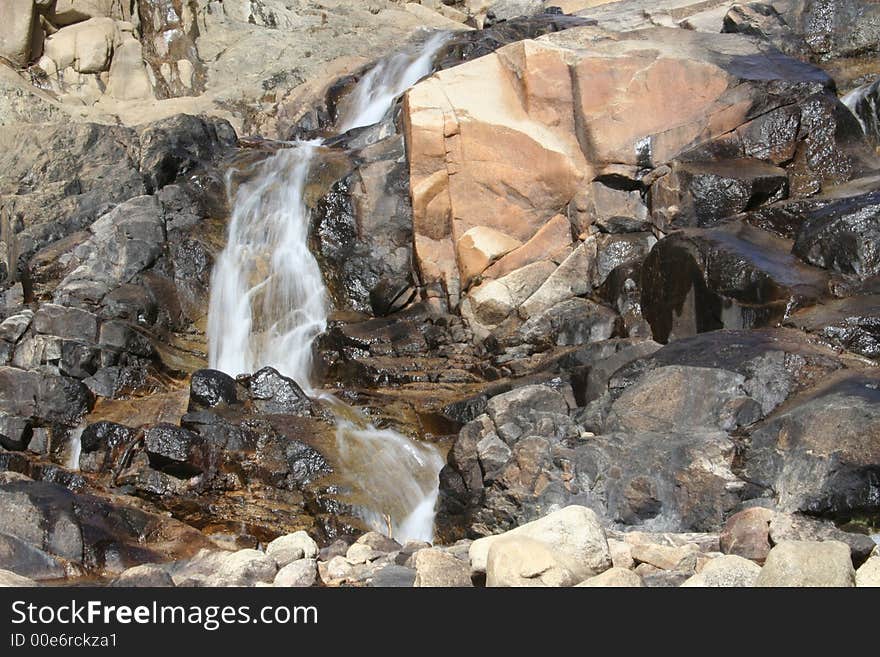 A cascading waterfall in the Rocky Mountain National Park in Colorado. A cascading waterfall in the Rocky Mountain National Park in Colorado.