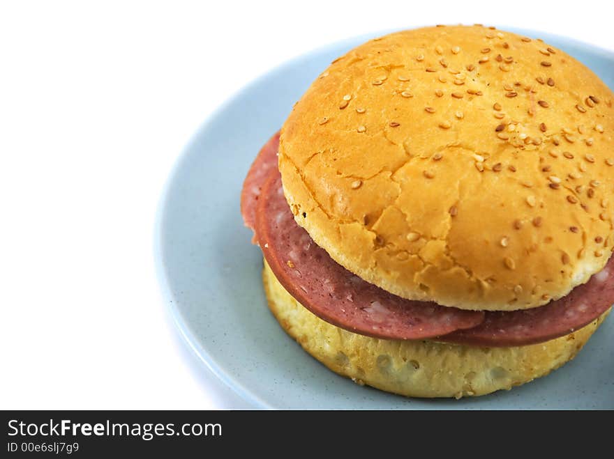 Beautiful hamburger on a blue plate on a white background