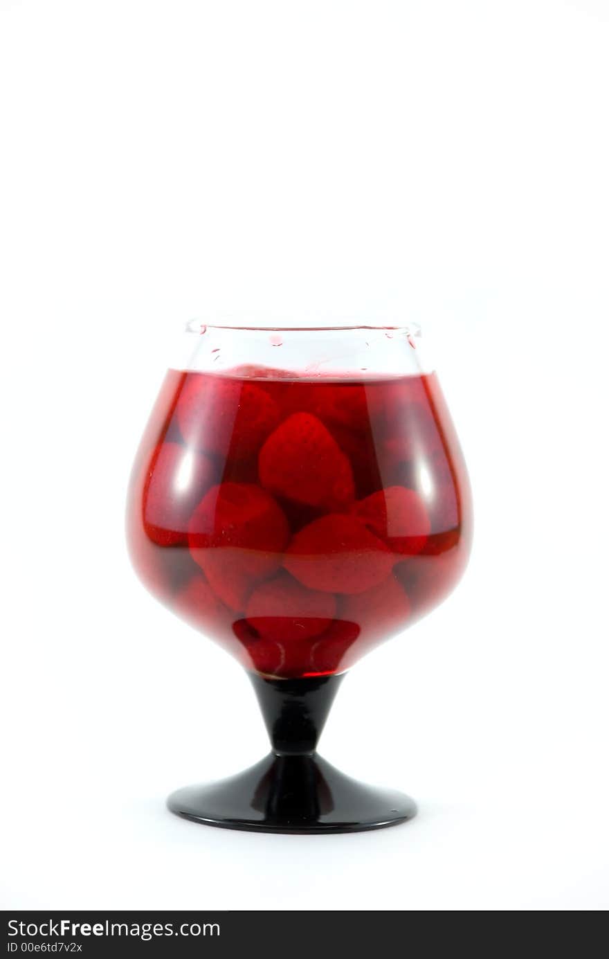 Beautiful glass with a strawberry syrup on a white background