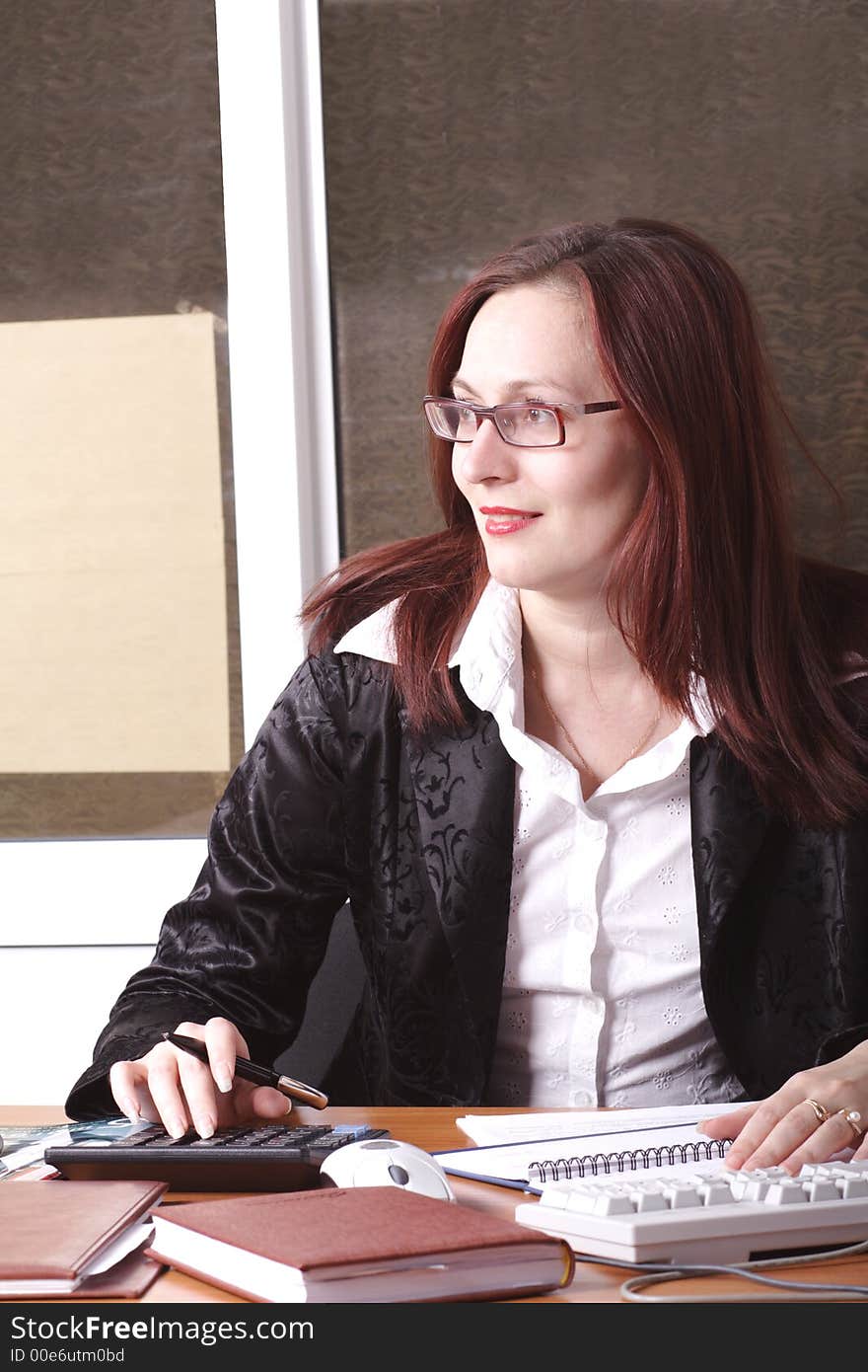 Portrait of a businesswoman when working. Shot in office. Portrait of a businesswoman when working. Shot in office.