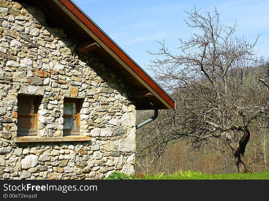 An old farm in the french countryside with an old tree. An old farm in the french countryside with an old tree