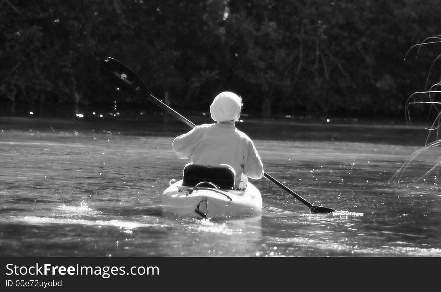 Photo image of a woman in a kayak going up stream in Weeki Wachee Springs. Photo image of a woman in a kayak going up stream in Weeki Wachee Springs.