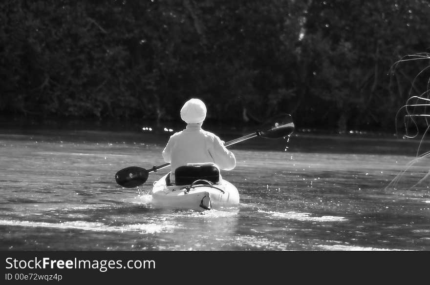 Photo image of a woman in a kayak going up stream in Weeki Wachee Springs. Photo image of a woman in a kayak going up stream in Weeki Wachee Springs.