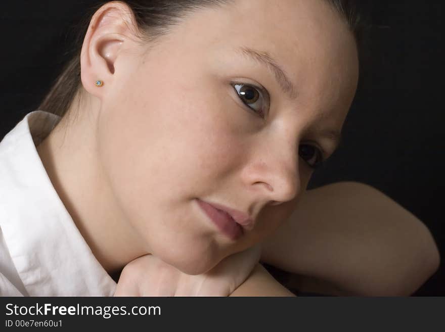 A close up portrait of young woman with strong side lighting. A close up portrait of young woman with strong side lighting