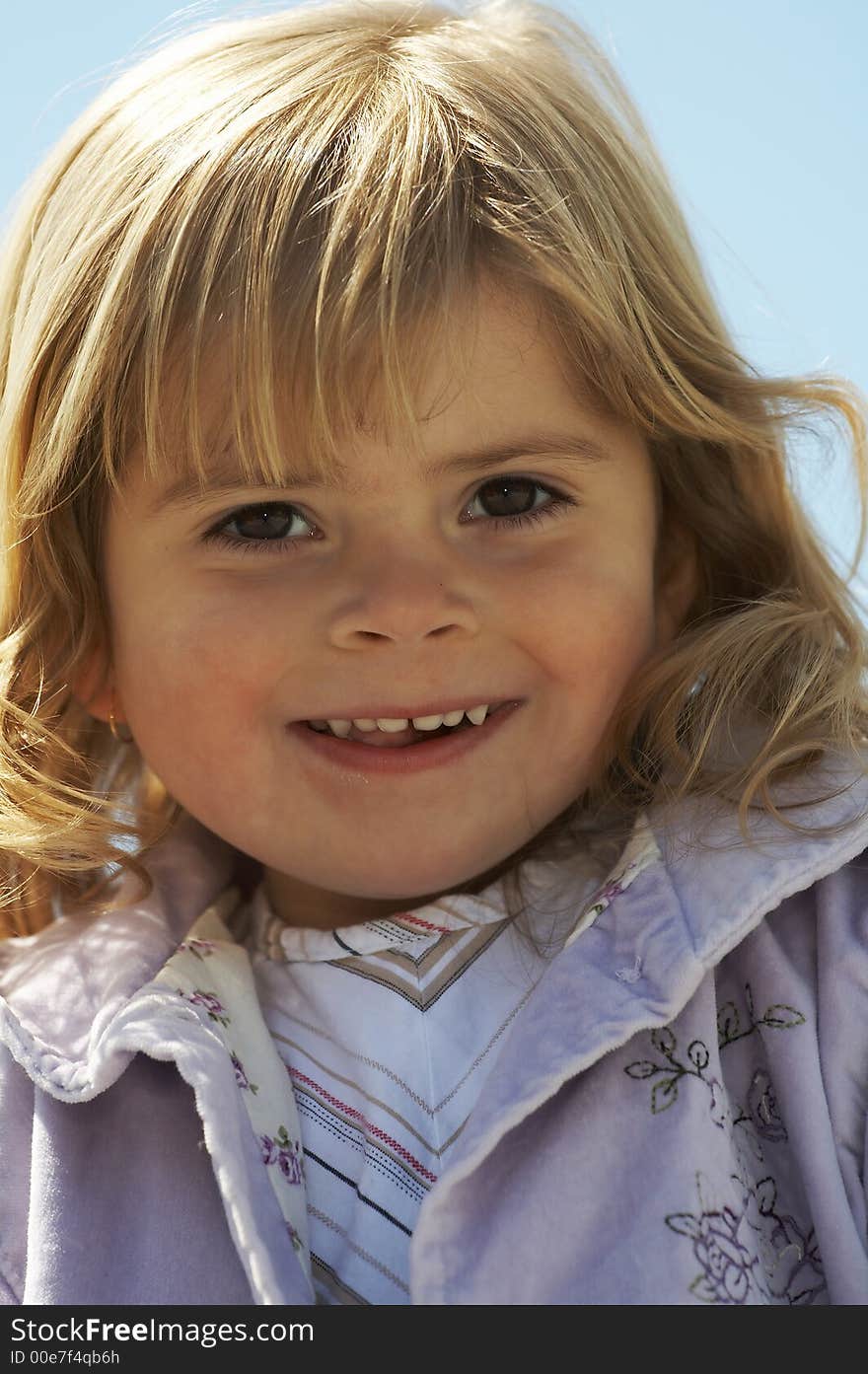 Young blond haired girl smiling. Young blond haired girl smiling