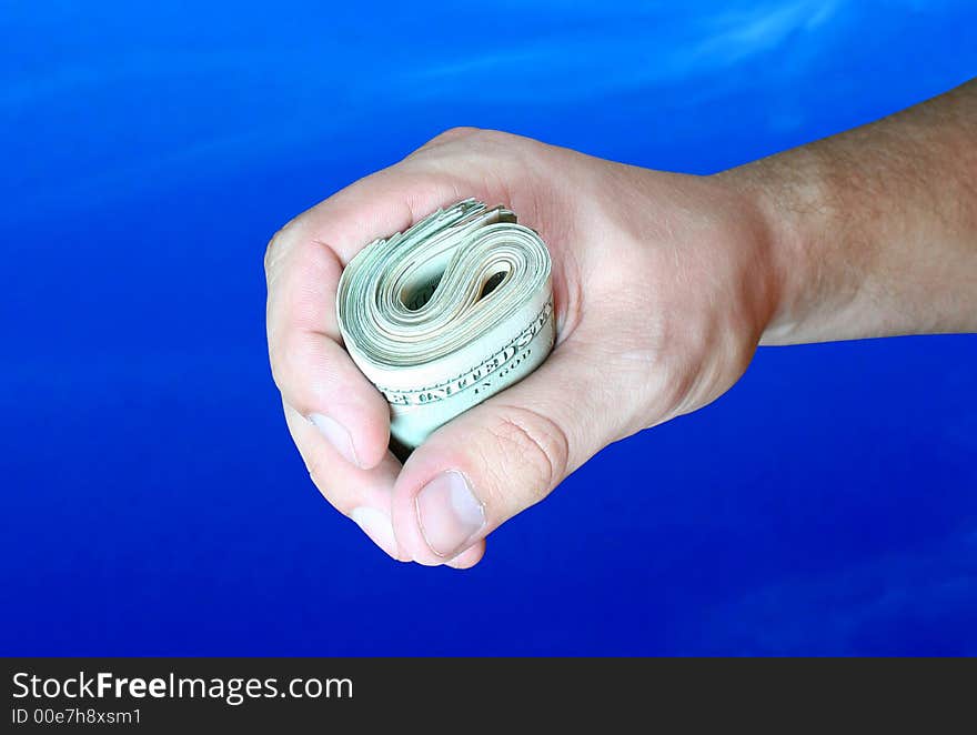 Dollar banknotes in hand on blue background. Dollar banknotes in hand on blue background