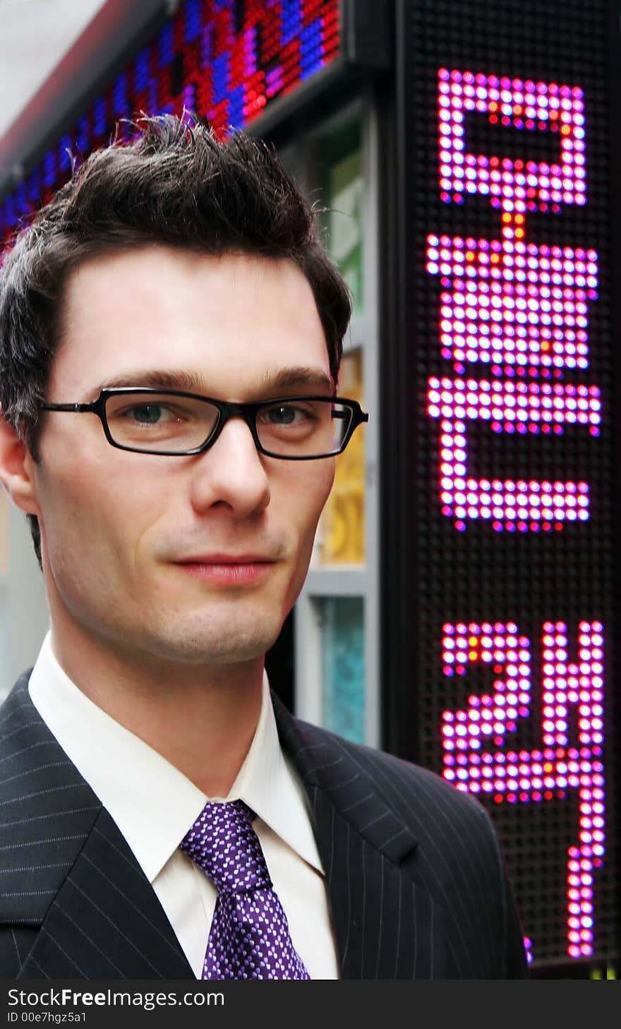 Businessman in a suit and tie with neon in the background. Businessman in a suit and tie with neon in the background