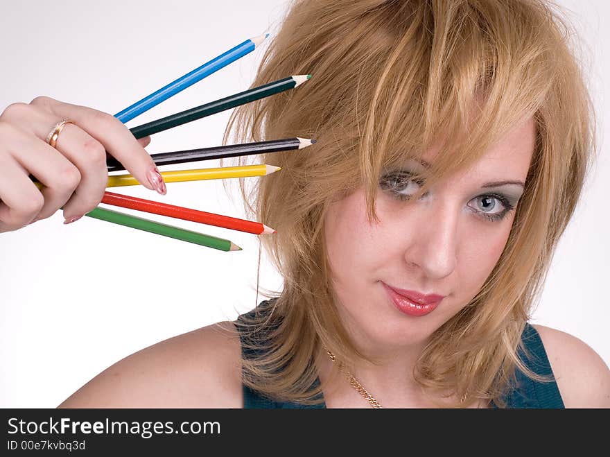 The girl with pencils on a white background