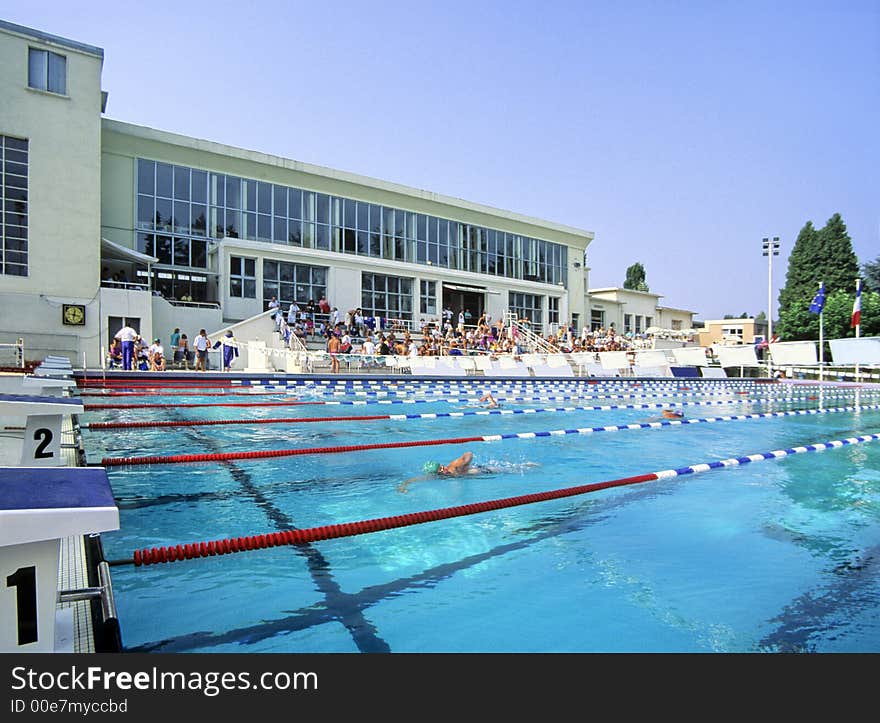 A sunny swimming pool during a competition.