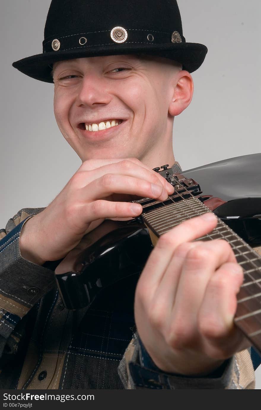 The musician smiles on a grey background