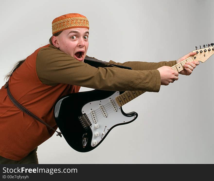 The musician smiles on a grey background