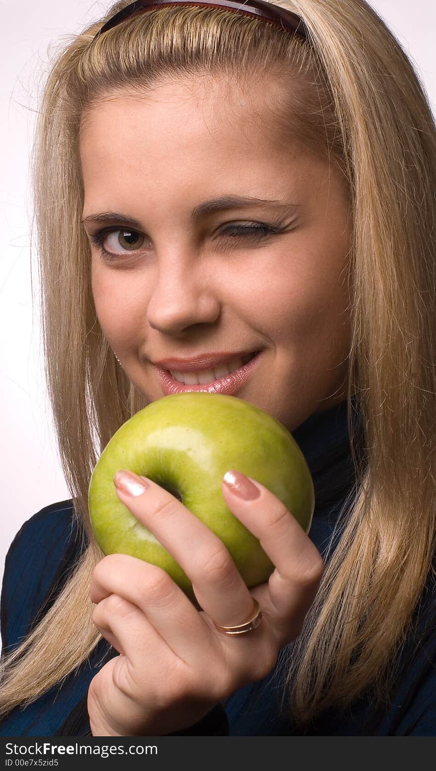 The girl with an apple on a white background