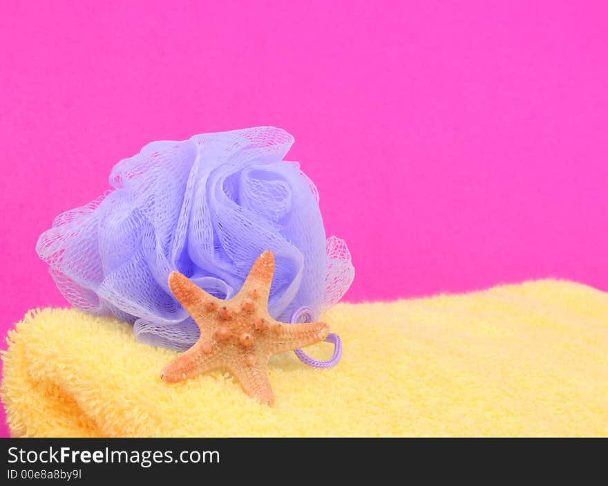 Sponge and Towel With Starfish on Pink Background